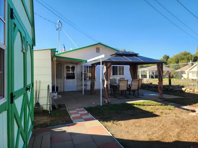 a front view of a house with swimming pool having outdoor seating