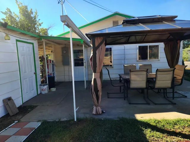 a view of a porch with furniture and floor to ceiling window