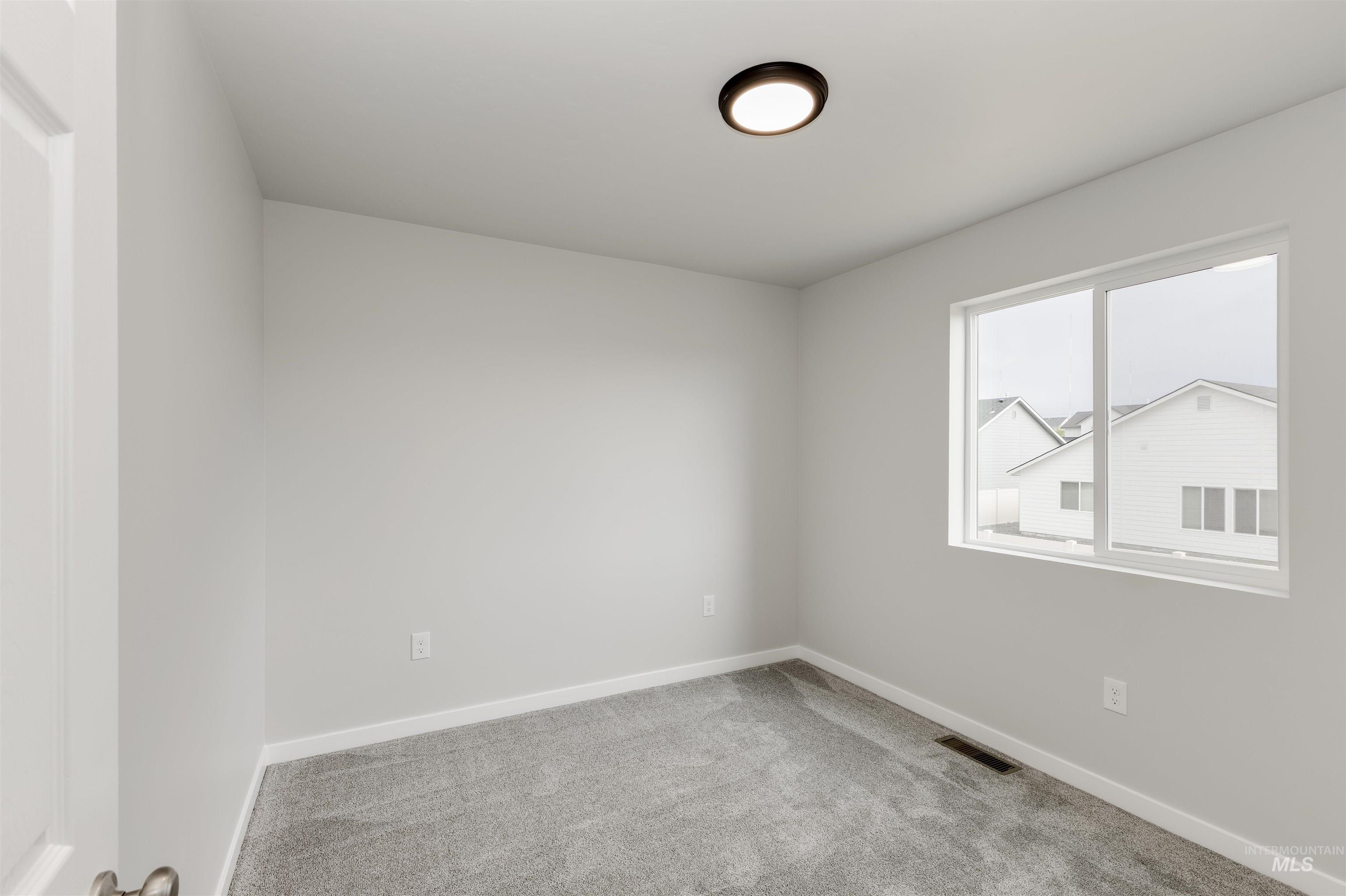 10865 Rutland Street Caldwell, ID 83605 - Photo 13 of 20 Unfurnished room with carpet and baseboards