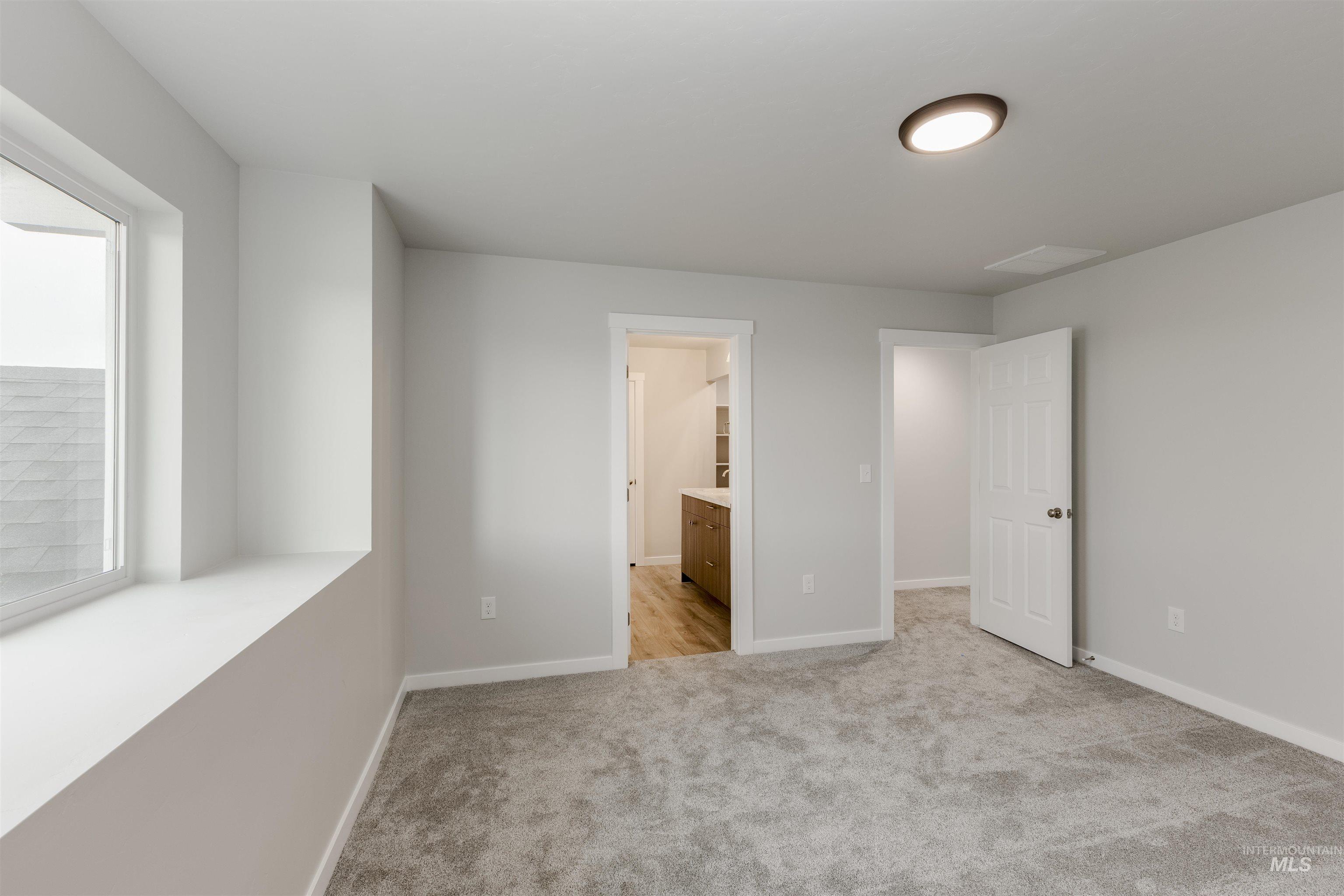10865 Rutland Street Caldwell, ID 83605 - Photo 16 of 20 Unfurnished bedroom with ensuite bath and light carpet