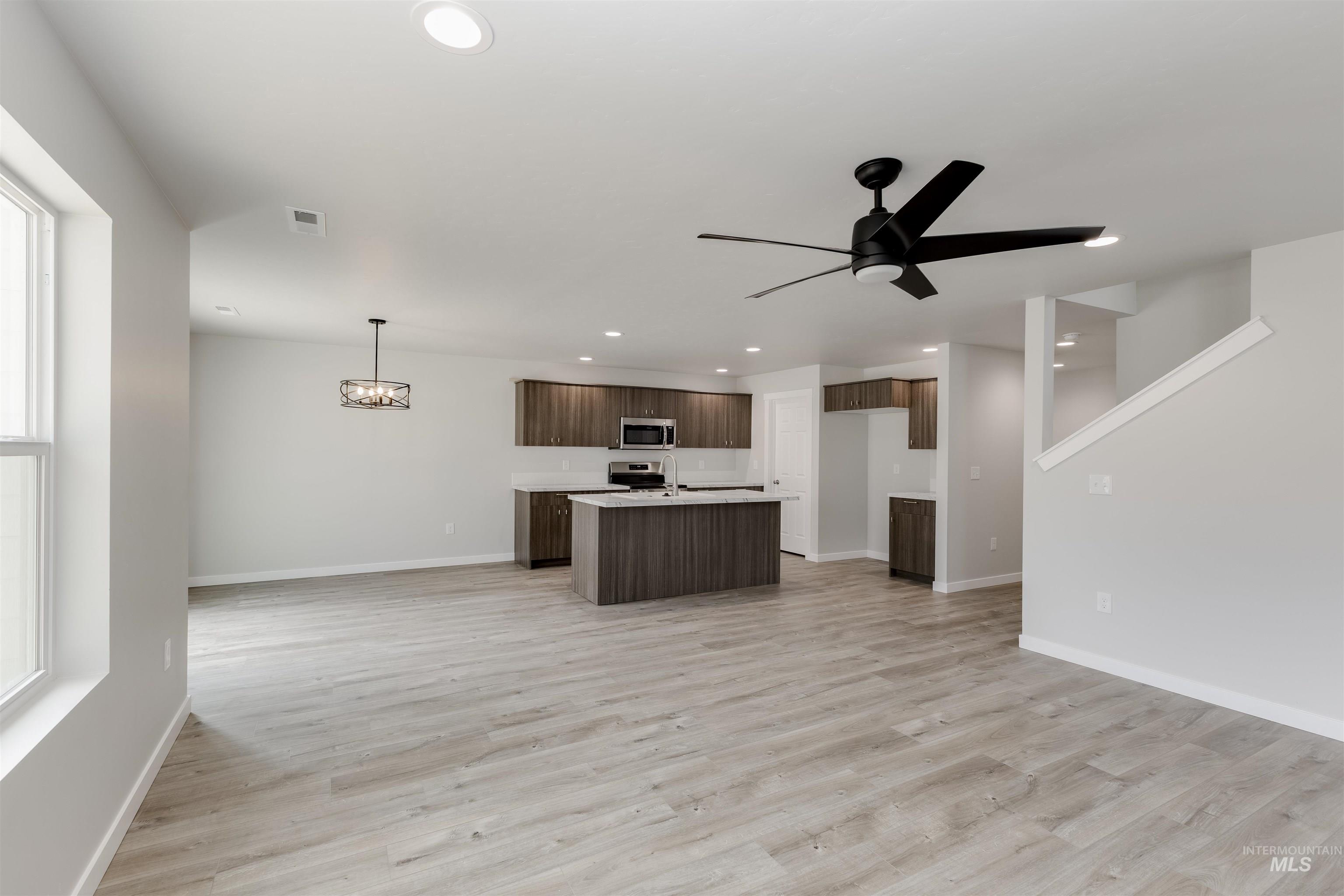 10865 Rutland Street Caldwell, ID 83605 - Photo 20 of 20 Kitchen with open floor plan, light countertops, a kitchen island with sink, light wood-style floors, and recessed lighting