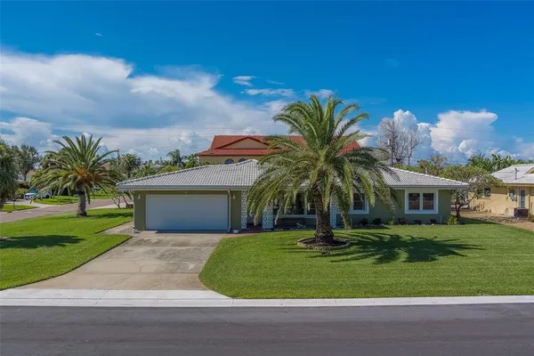 a front view of a house with a garden and a yard