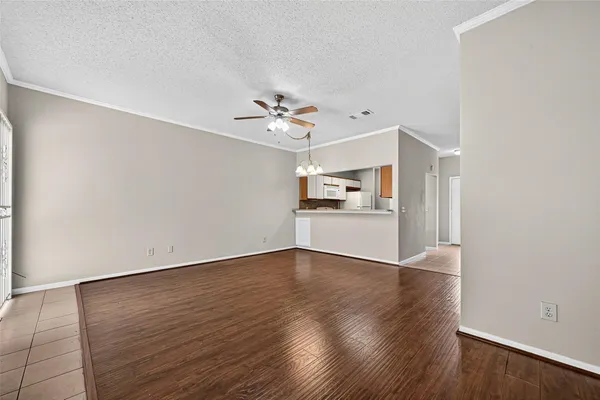 a view of a room with wooden floor