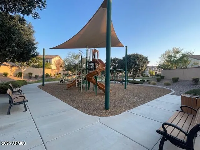 a view of a patio with table and chairs under an umbrella