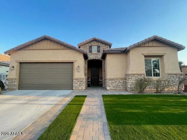 a front view of a house with a yard and garage