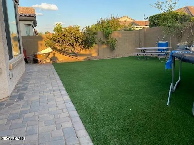 a backyard of a house with table and chairs