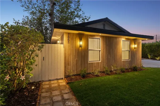 a view of a house with a yard and a garden