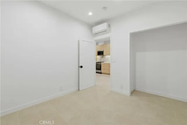 a kitchen with a refrigerator and a stove top oven
