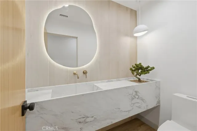 a view of a kitchen with a sink and a chandelier