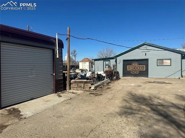a view of a house with backyard and sitting area