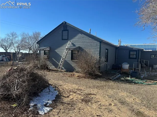 a view of a house with a yard and sitting area
