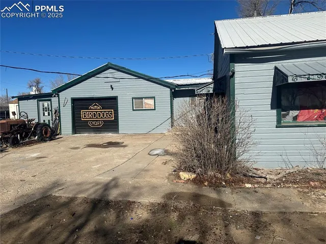 a backyard of a house with garage and window
