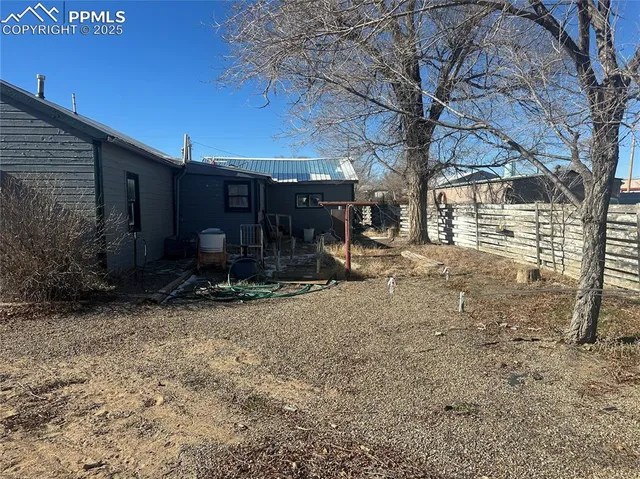 a view of a house with a yard and tree