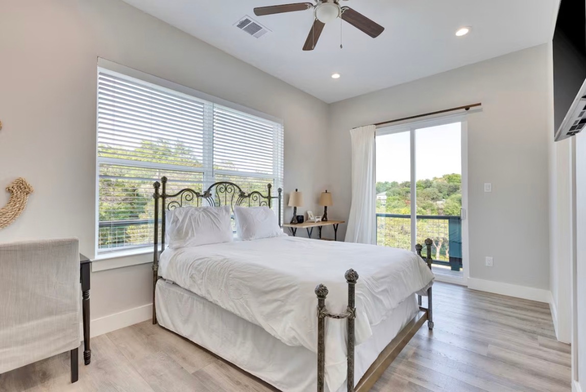 16323 Lake Loop Austin, TX 78734 - Photo 12 of 30 Bedroom with wood finished floors, access to outside, recessed lighting, and a ceiling fan