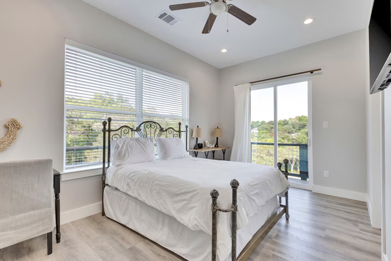 16323 Lake Loop Austin, TX 78734 - Photo 12 of 37 a bedroom with a large bed and a window
