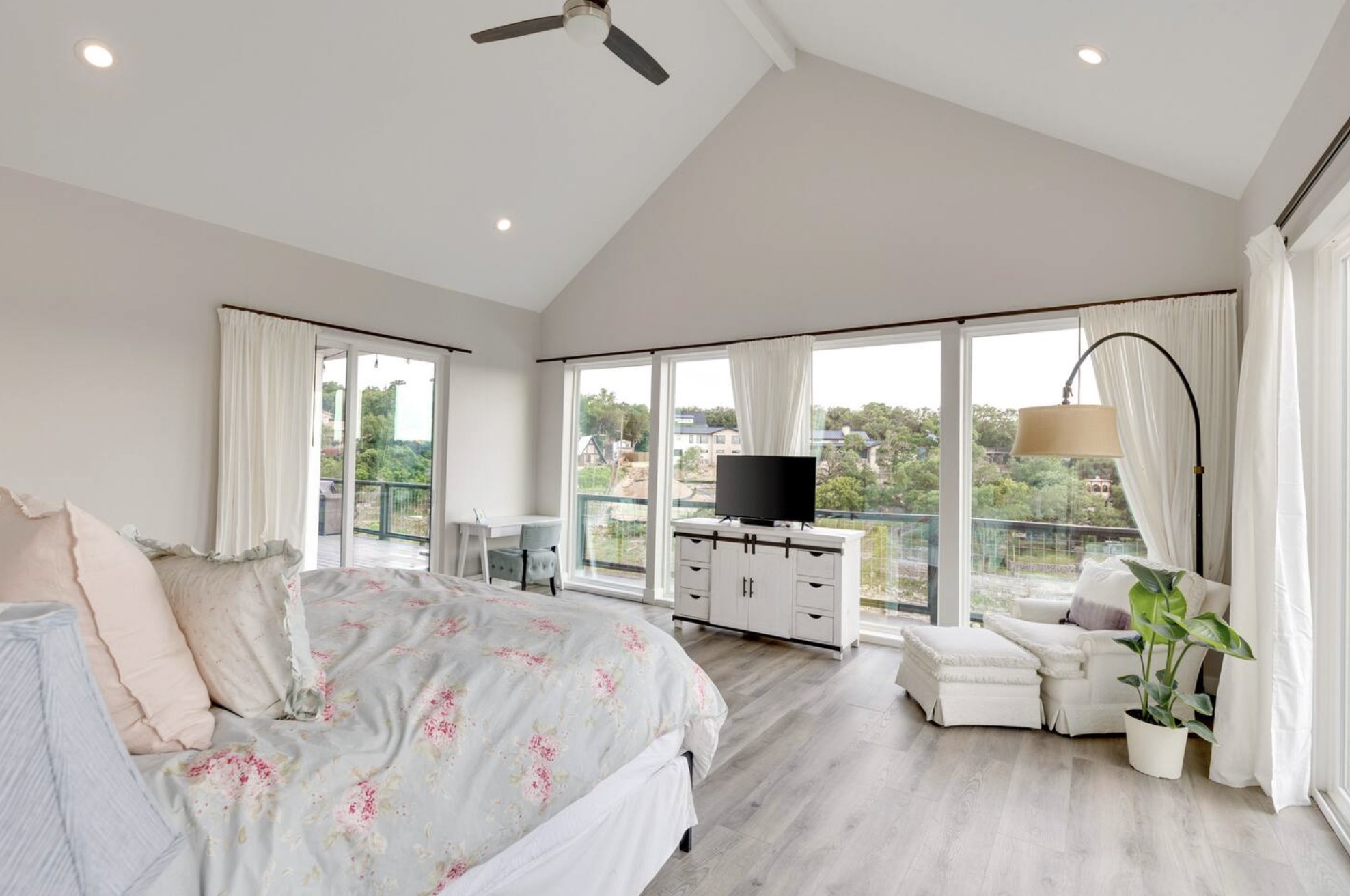 16323 Lake Loop Austin, TX 78734 - Photo 14 of 37 a large bedroom with a bed and large flat screen tv