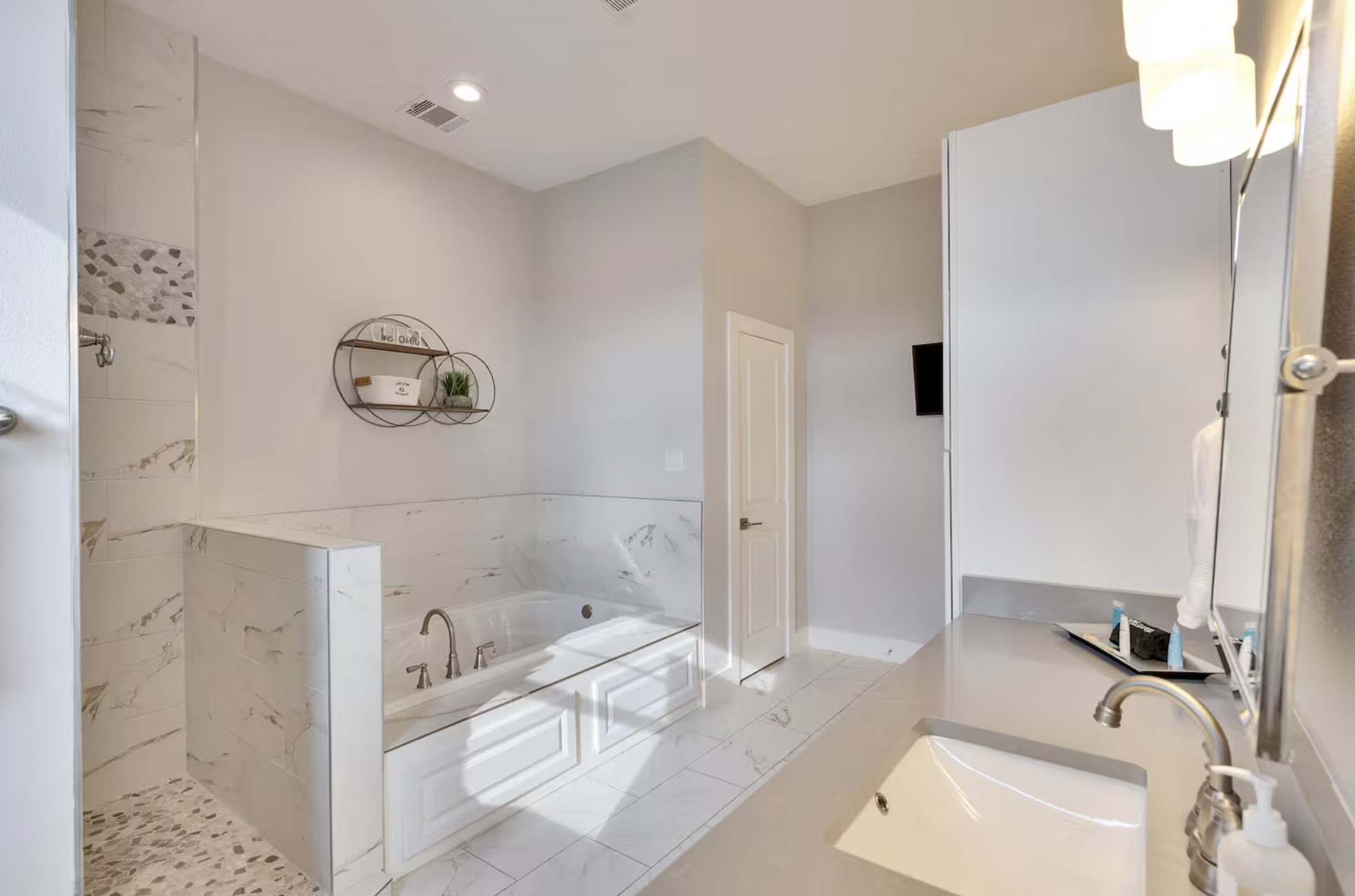 16323 Lake Loop Austin, TX 78734 - Photo 15 of 37 a bathroom with a tub sink and mirror