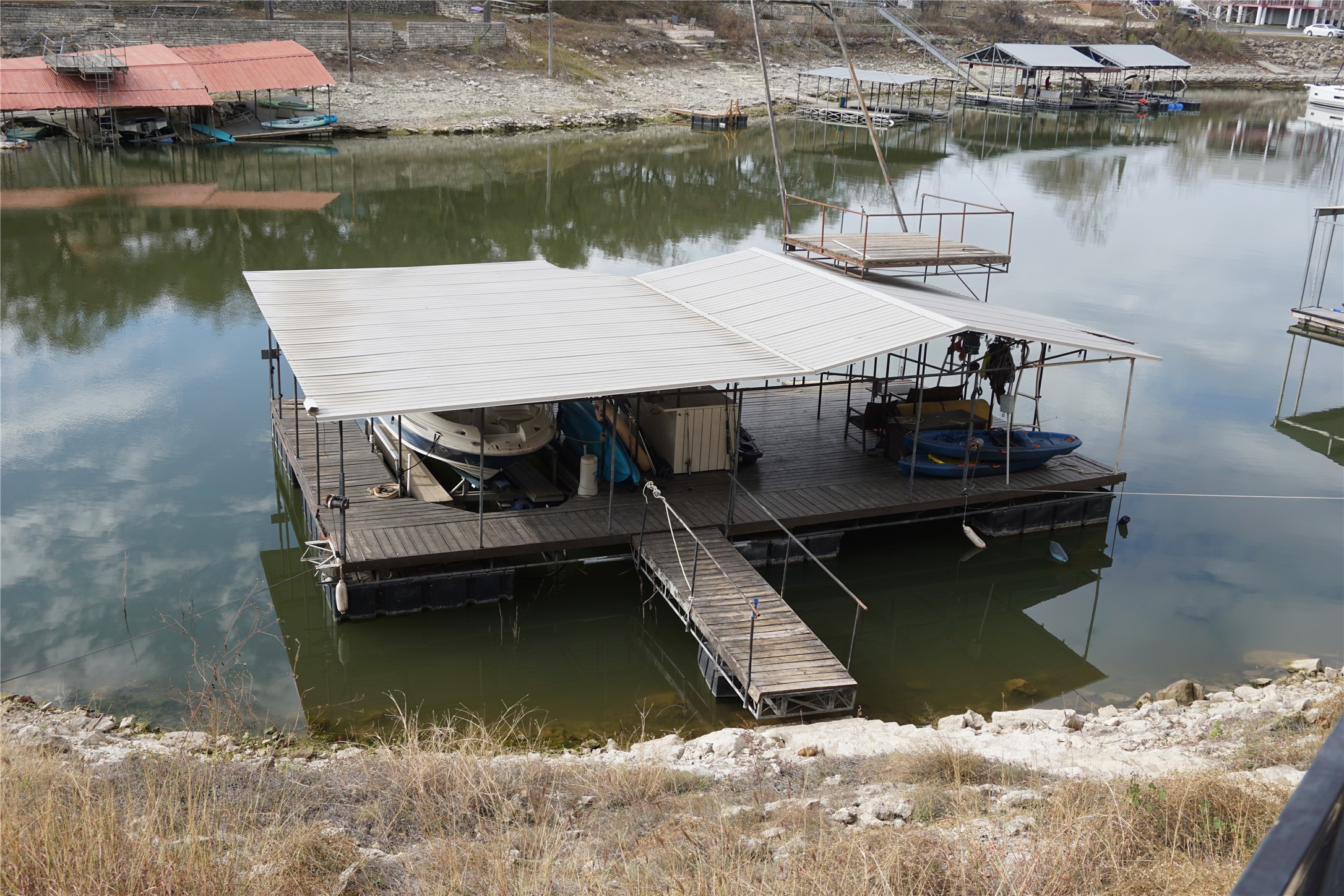 16323 Lake Loop Austin, TX 78734 - Photo 19 of 37 a view of a lake with boats and a wooden bridge