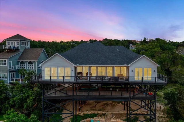 a front view of a house with a yard and furniture
