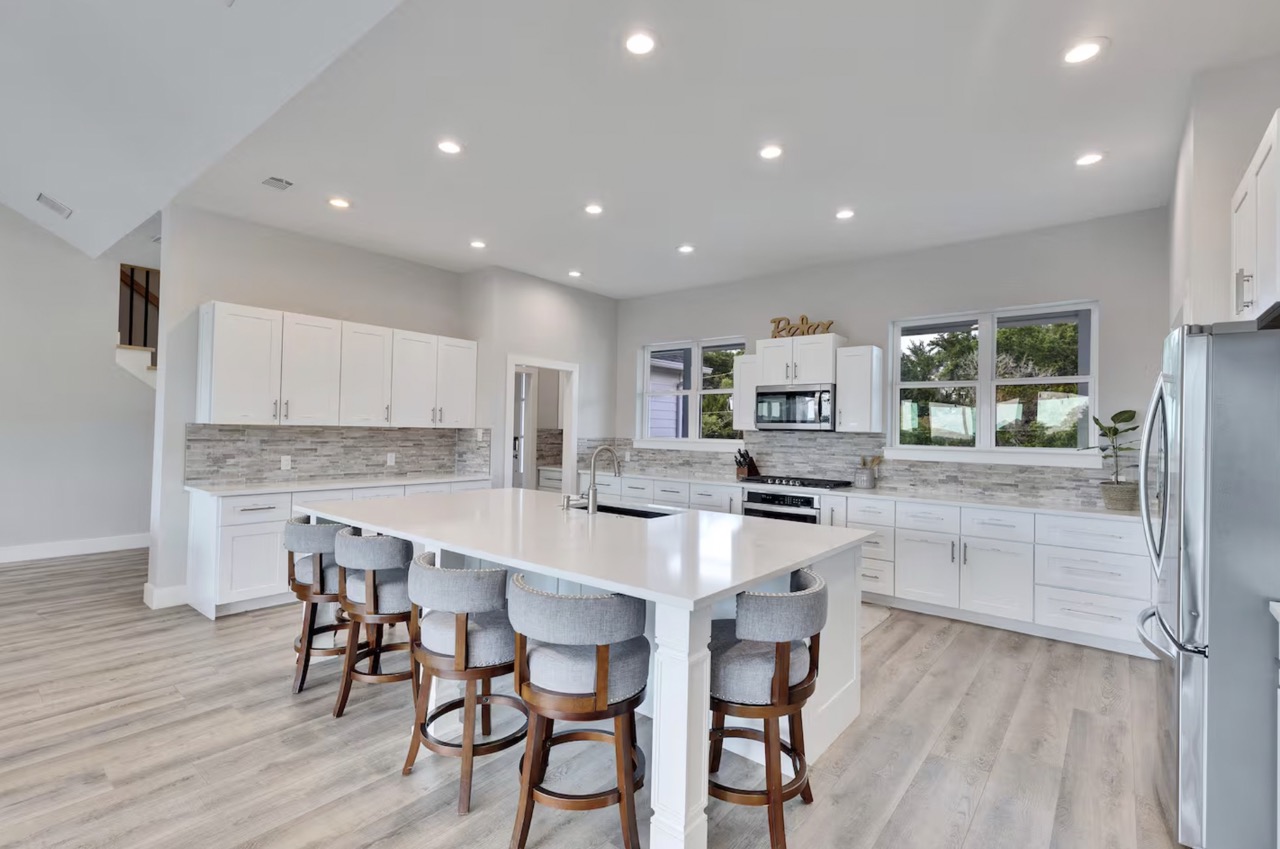 16323 Lake Loop Austin, TX 78734 - Photo 2 of 37 a large kitchen with a table and chairs in it