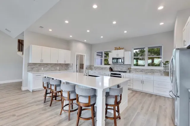 a large kitchen with a table and chairs in it