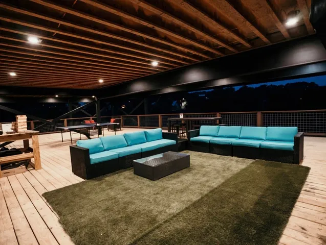 a outdoor living space with furniture and a fireplace