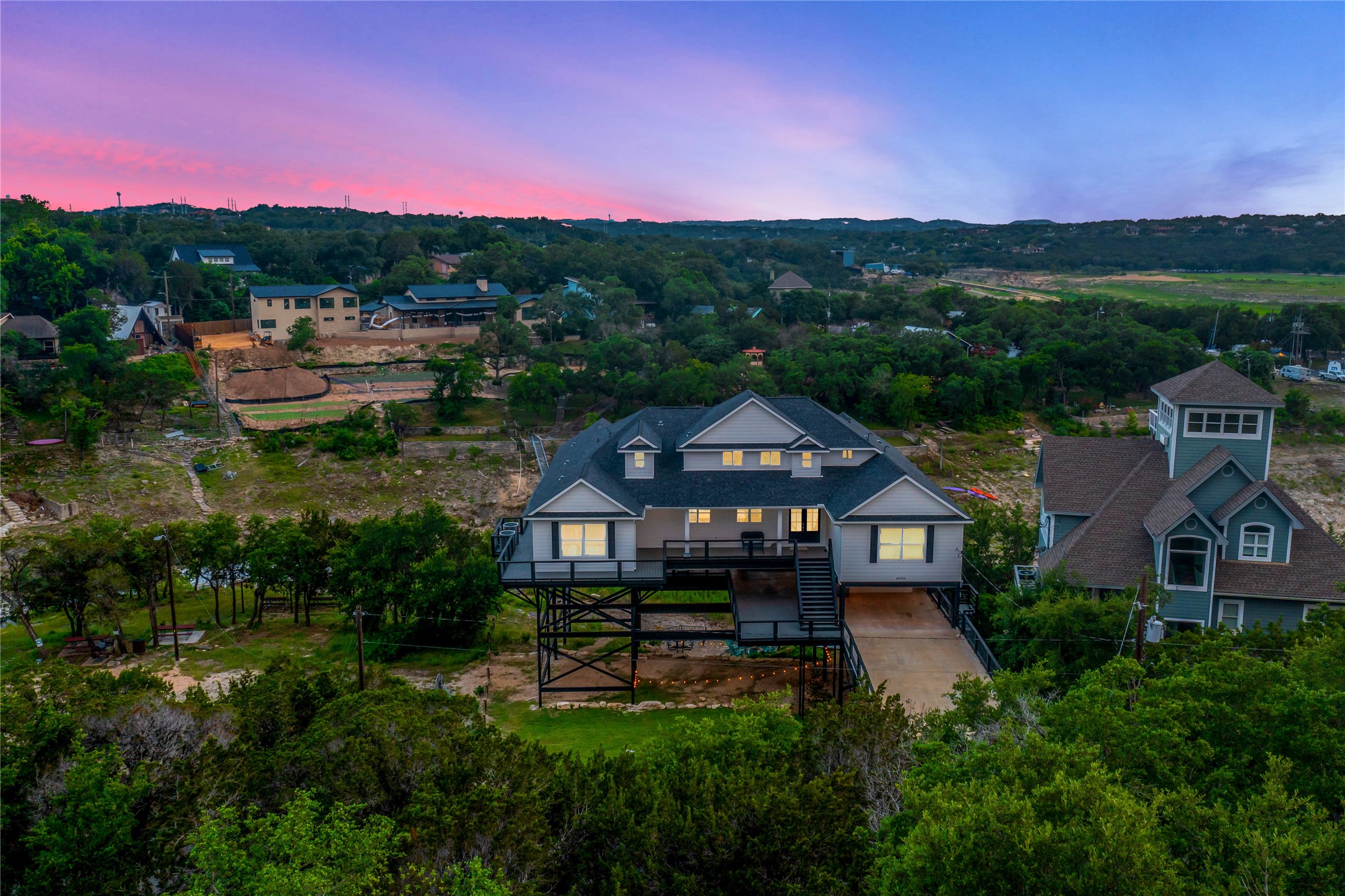 16323 Lake Loop Austin, TX 78734 - Photo 26 of 37 a front view of a house with a yard and lake view