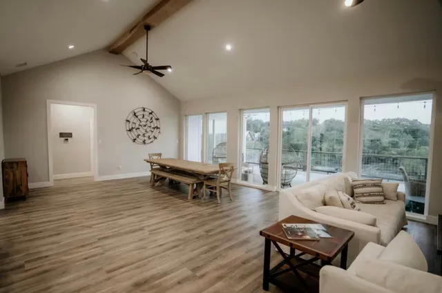 a living room with furniture and a wooden floor