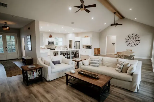 a living room with furniture and a wooden floor