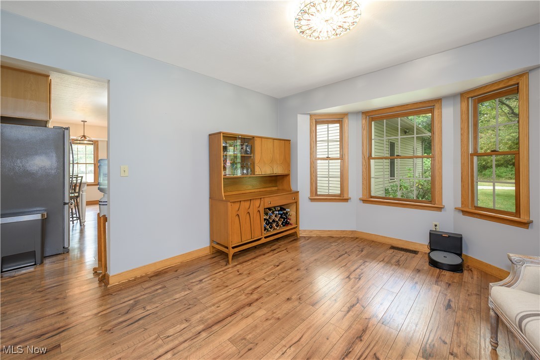 6640 Giddings Road Rootstown, OH 44272 - Photo 21 of 49 Unfurnished living room with wood-type flooring and baseboards