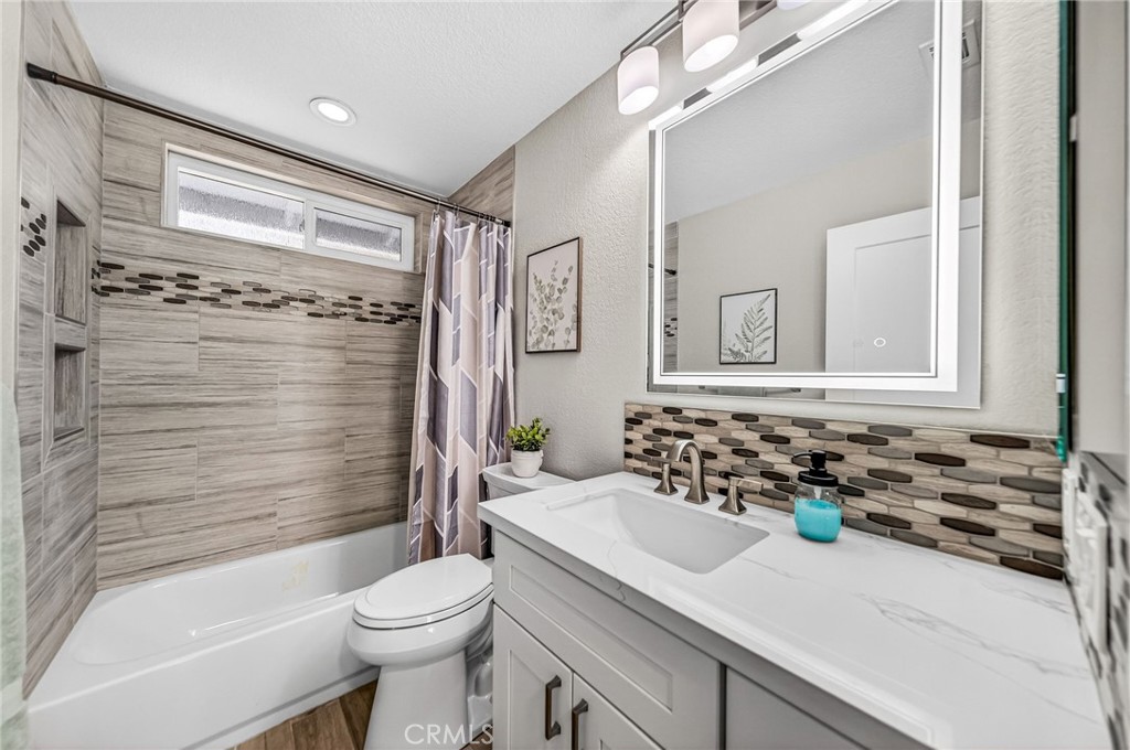 9290 Hot Springs Road Corona, CA 92883 - Photo 13 of 25 a bathroom with a sink a toilet and shower