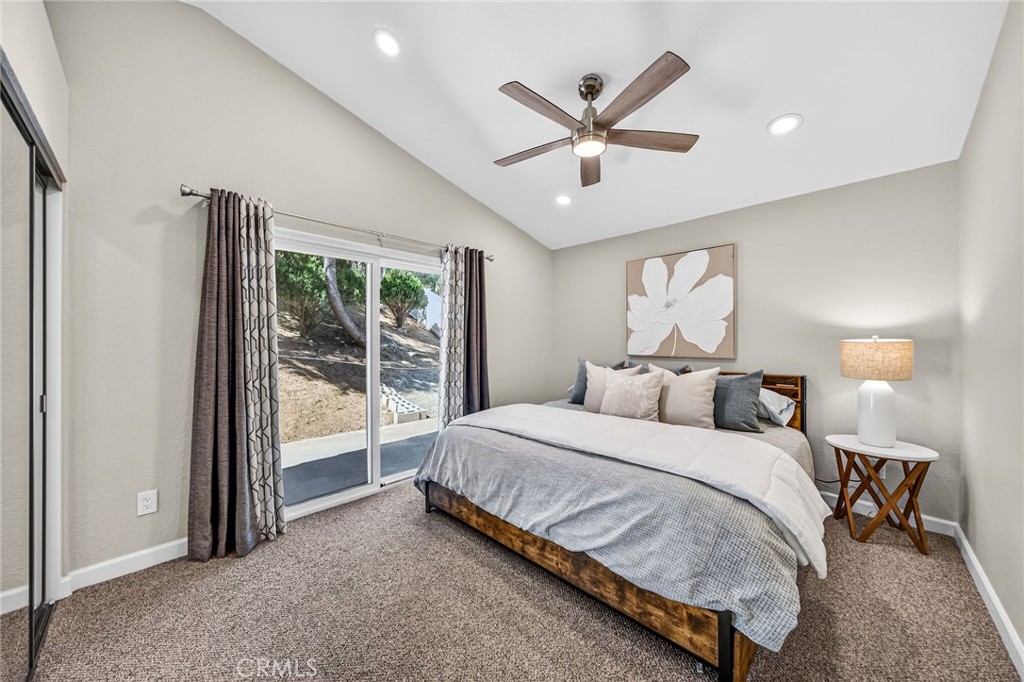 9290 Hot Springs Road Corona, CA 92883 - Photo 14 of 25 a bedroom with a large bed and a chandelier