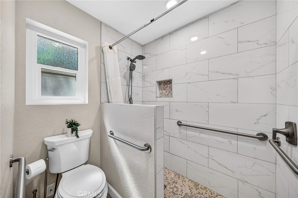 9290 Hot Springs Road Corona, CA 92883 - Photo 17 of 25 a white toilet sitting next to a bathroom sink