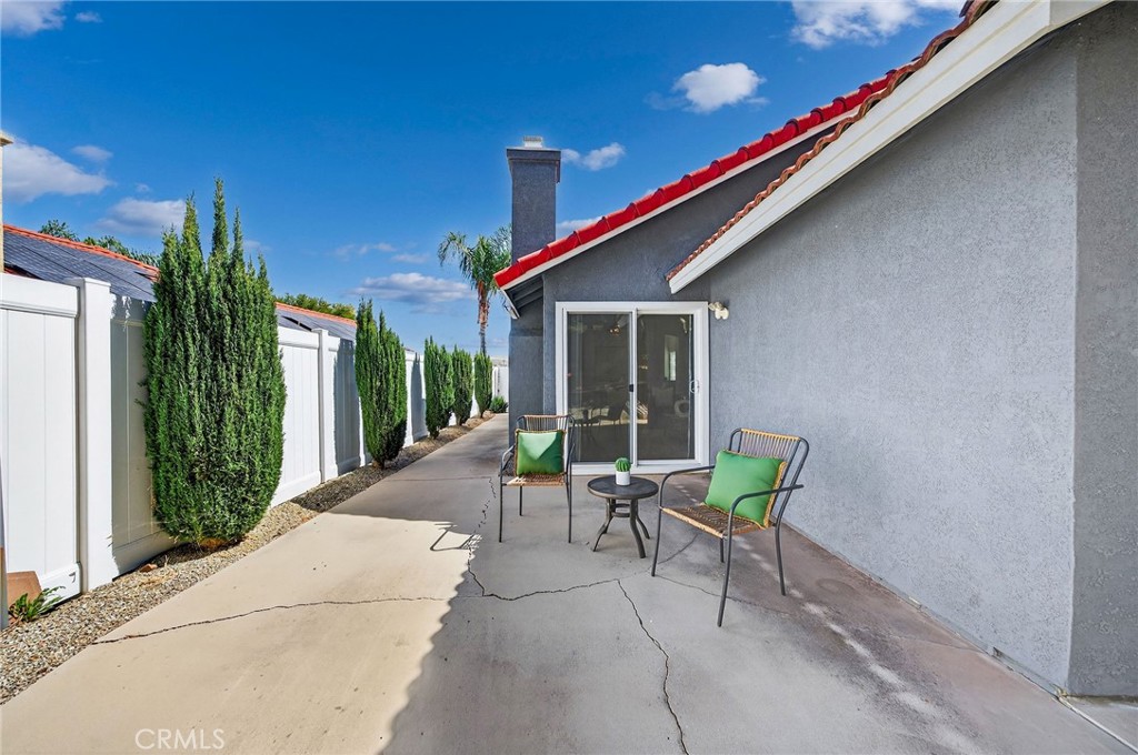9290 Hot Springs Road Corona, CA 92883 - Photo 18 of 25 a view of a patio with a table and chairs and potted plants