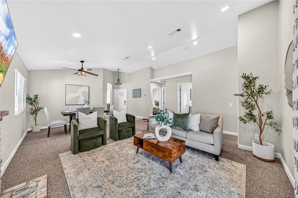 9290 Hot Springs Road Corona, CA 92883 - Photo 2 of 25 a living room with furniture and a potted plant