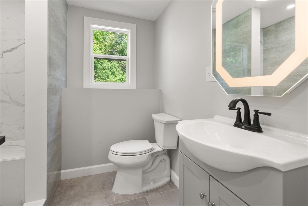456 Parsonage Street Marshfield, MA 02050 - Photo 16 of 41 a bathroom with a sink a toilet and a mirror