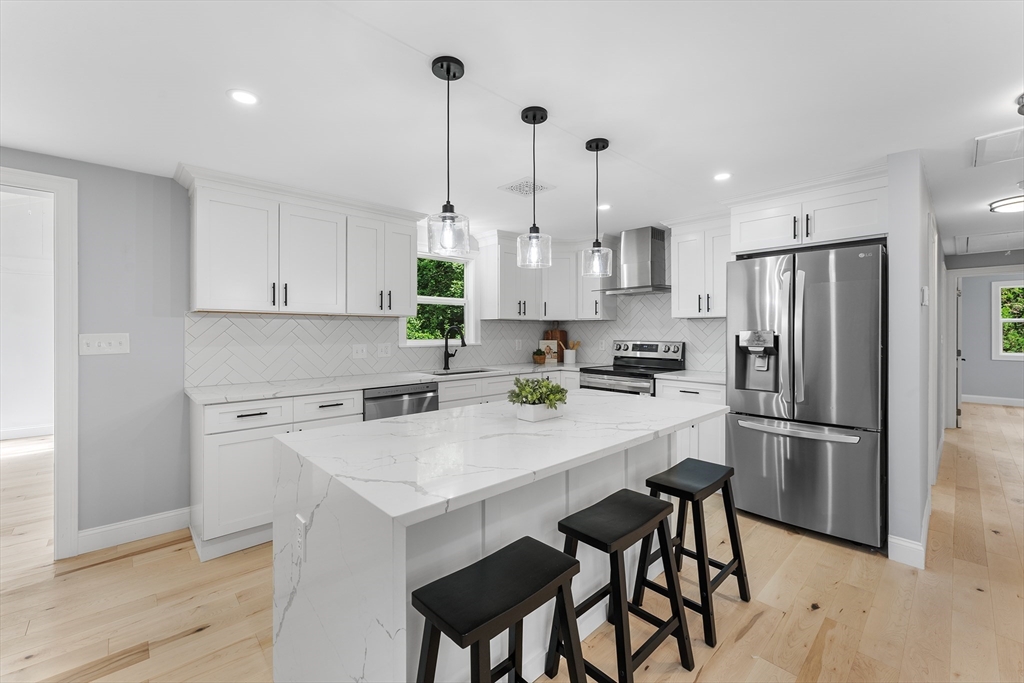 456 Parsonage Street Marshfield, MA 02050 - Photo 5 of 41 a kitchen with refrigerator cabinets and wooden floor