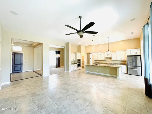 a view of a livingroom with a ceiling fan and window
