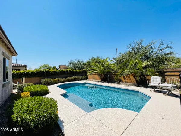 a view of a house with backyard and sitting area
