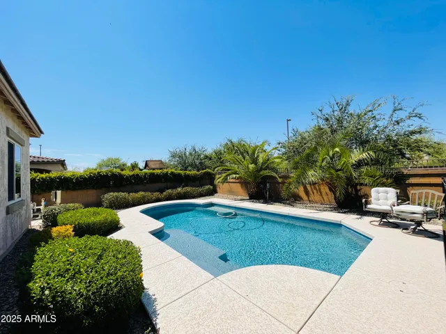 a view of a house with backyard and sitting area