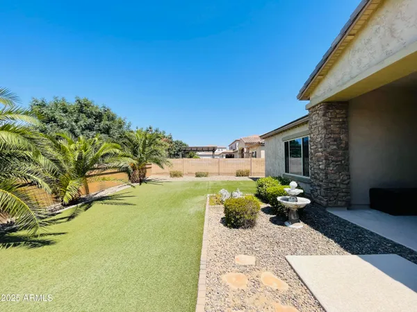 a view of a house with backyard and sitting area