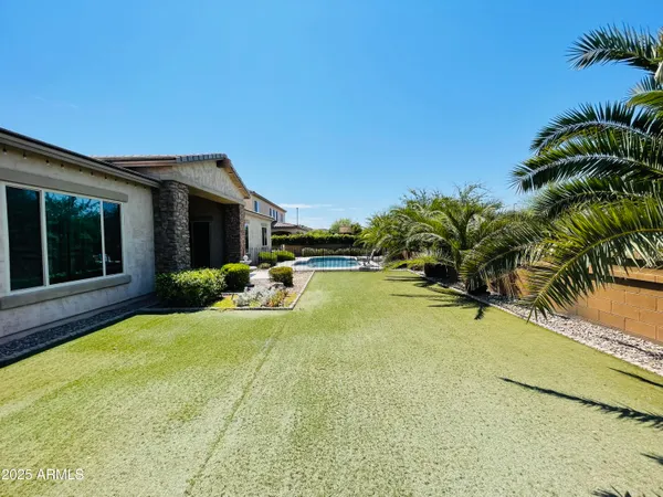 a spacious bathroom with a double vanity sink a mirror and a bathtub