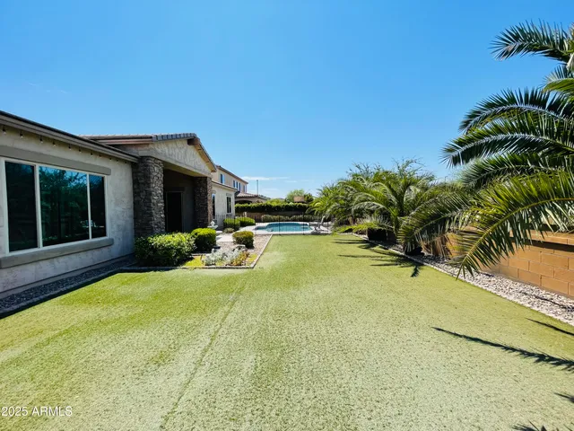 a spacious bathroom with a double vanity sink a mirror and a bathtub