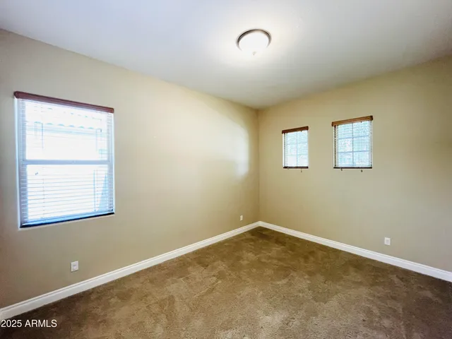 an empty room with closet area