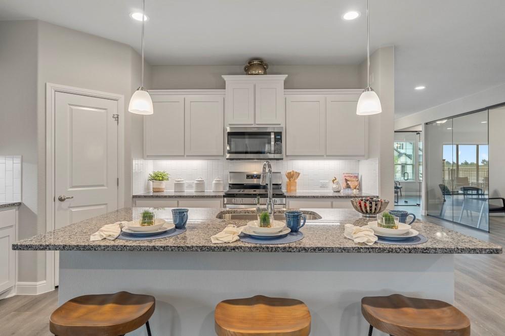 141 Leon Avenue Rhome, TX 76078 - Photo 29 of 31 Kitchen-All Home and community information, including pricing, included features, terms, availability and amenities, are subject to change at any time without notice or obligation. All Drawings, pictures, photographs, video, square footages, floor plans, elevations, features, colors and sizes are approximate for illustration purposes only and will vary from the homes as built.