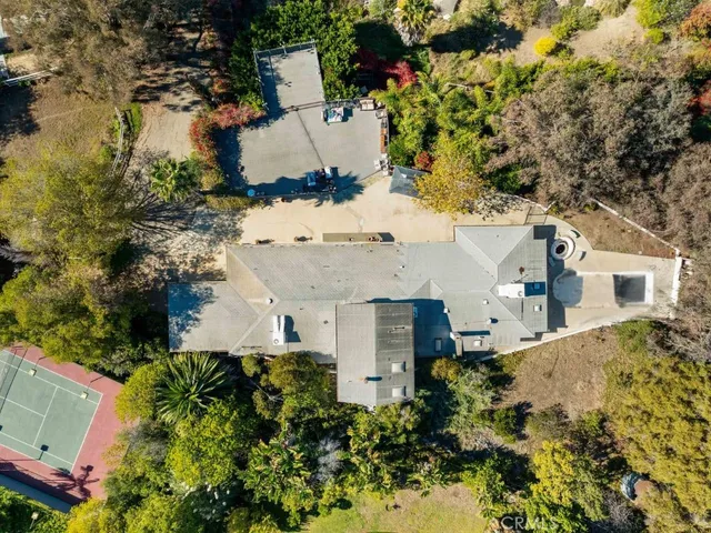 an aerial view of a house with a yard