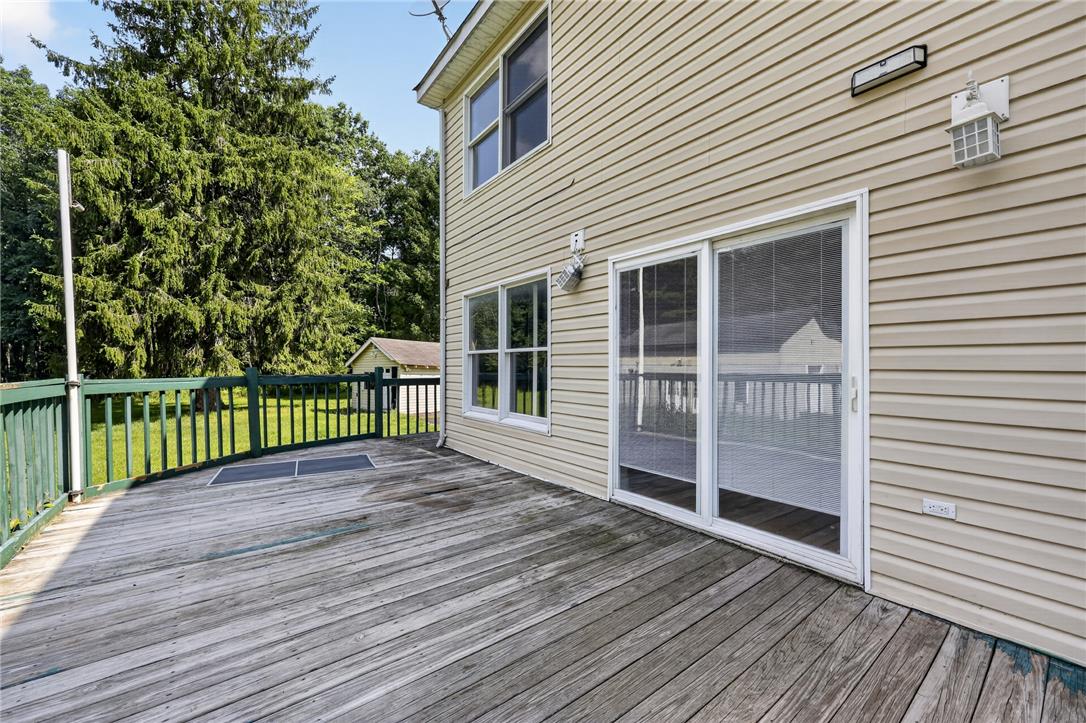 2882 Locust Ridge Road Pocono Lake, PA 18347 - Photo 11 of 45 A spacious wooden deck extends from the siding-clad home, offering a private outdoor living area.