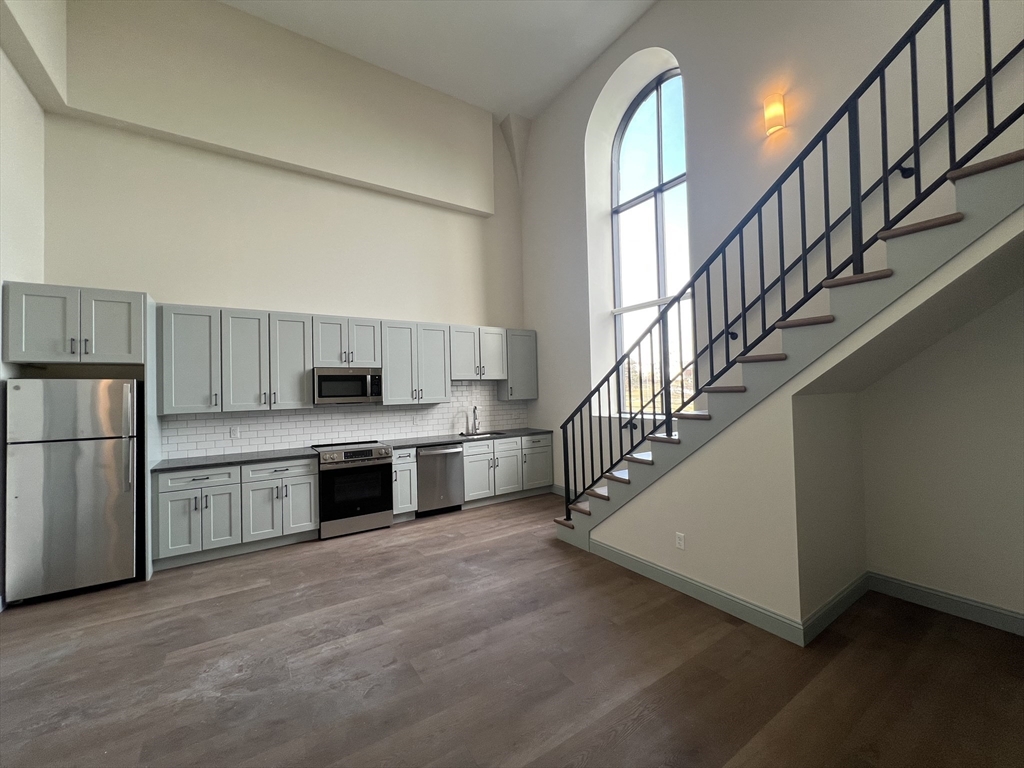 a kitchen with a refrigerator and a sink