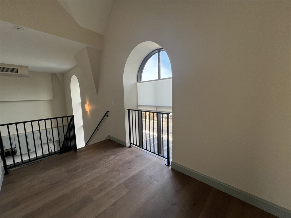 160 Seabury Street, Unit 29 Fall River, MA 02720 - Photo 11 of 17 an empty room with wooden floor mirror and windows