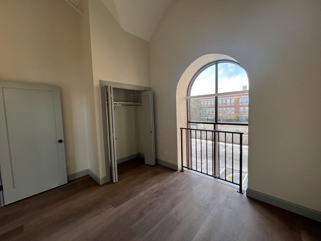 160 Seabury Street, Unit 29 Fall River, MA 02720 - Photo 12 of 17 an empty room with wooden floor and a window